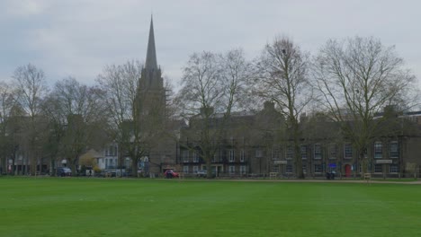 pan across trees, grassy field, and historic neighborhood in cambridge england