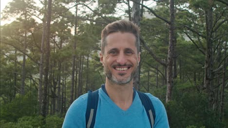 cheerful male traveler in coniferous forest