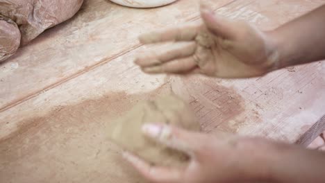 young woman makes a jug of clay. female hands mold pottery