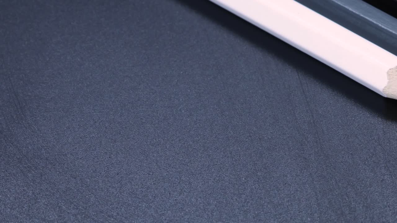 crayones blancos, grises y negros girando lentamente en 4k, toma macro