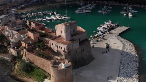 aerial close up view of castello arabo normanno located beside castellammare del golfo port