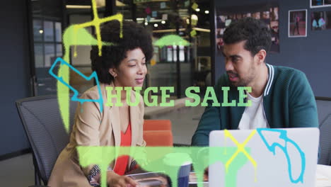 discussing animation and colorful graphics, colleagues in office with huge sale text