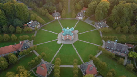 drone over star formation of complex pavilions and clemenswerth palace in lower saxony near sogel, germany