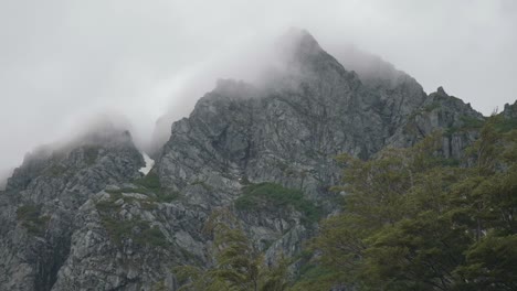 General-shoot-of-a-huge-granite-wall-on-the-distance-with-clouds-passing-by