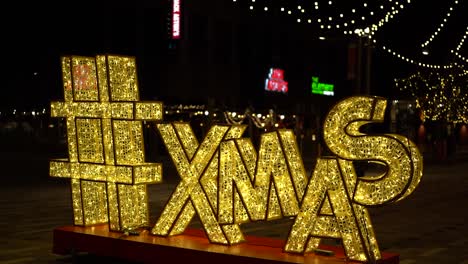 Elegant-slow-motion-shot-of-a-giant-ornamental-LED-Christmas-"XMAS"-letter-sign-at-Landsdowne-Park,-in-Ottawa,-Canada