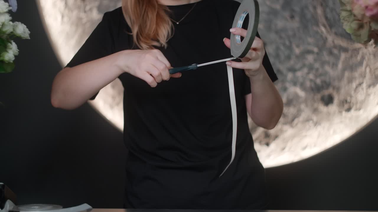 Florist Working with Tape and Flowers