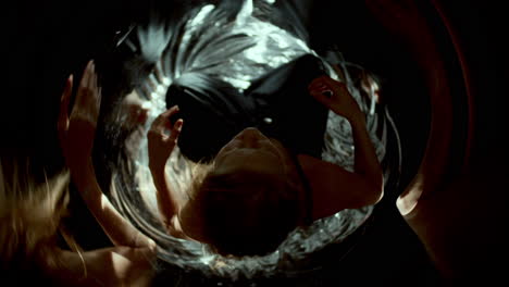 woman sitting amidst surreal swirling reflections and distortions