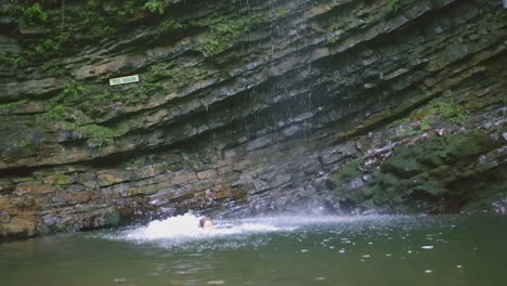 swimming in a waterfall pool