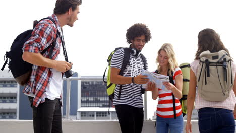 Casual-group-of-friends-looking-at-map