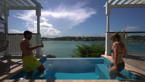 couple spending a romantic moment in a pool at a seaside resort in sunny antigua