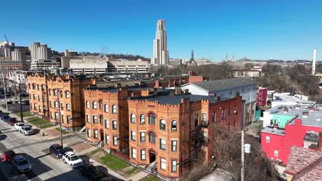 aerial shot of historic houses in pittsburgh, pennsylvania with pitt cathedral of learning in background