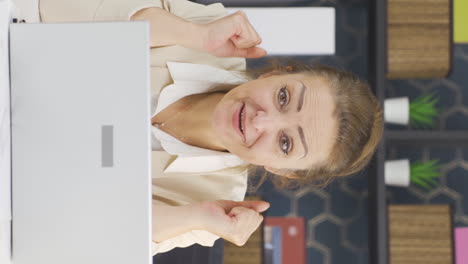 Vertical-video-of-Happy-and-cheerful-talking-business-woman-looking-at-camera.