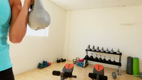 fit woman exercising with kettlebell 4k