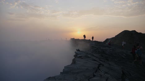 thick smoke coming from the dallol’s crater in ethiopia, welcomes the hikers as they reach the top of the volcano