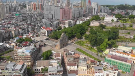 High-panning-aerial-view-of-Ruins-of-Saint-Paul's-and-Monte-do-Forte,-Macau