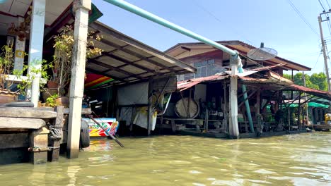 boat travels through bangkok's khlong lat mayom canal