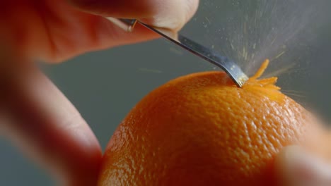 A-Tool-Runs-Against-the-Skin-of-an-Orange-to-Create-Zest