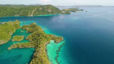 Scenic-flight-over-hidden-Fiji-islands-with-shallow-vibrant-coral-reef-system-below