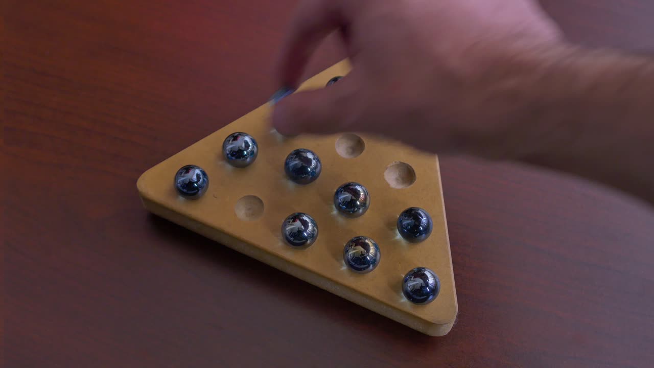 Playing Senku, Triangle Peg solitaire. Marbles game
