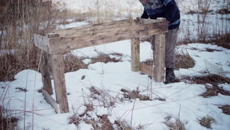 the man is clearing the area for the diy hot tub - static shot