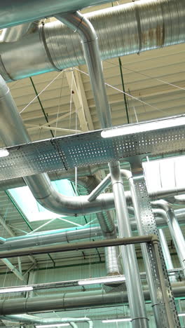 industrial factory ceiling with ventilation system and lights. ventilation ducts. vertical video