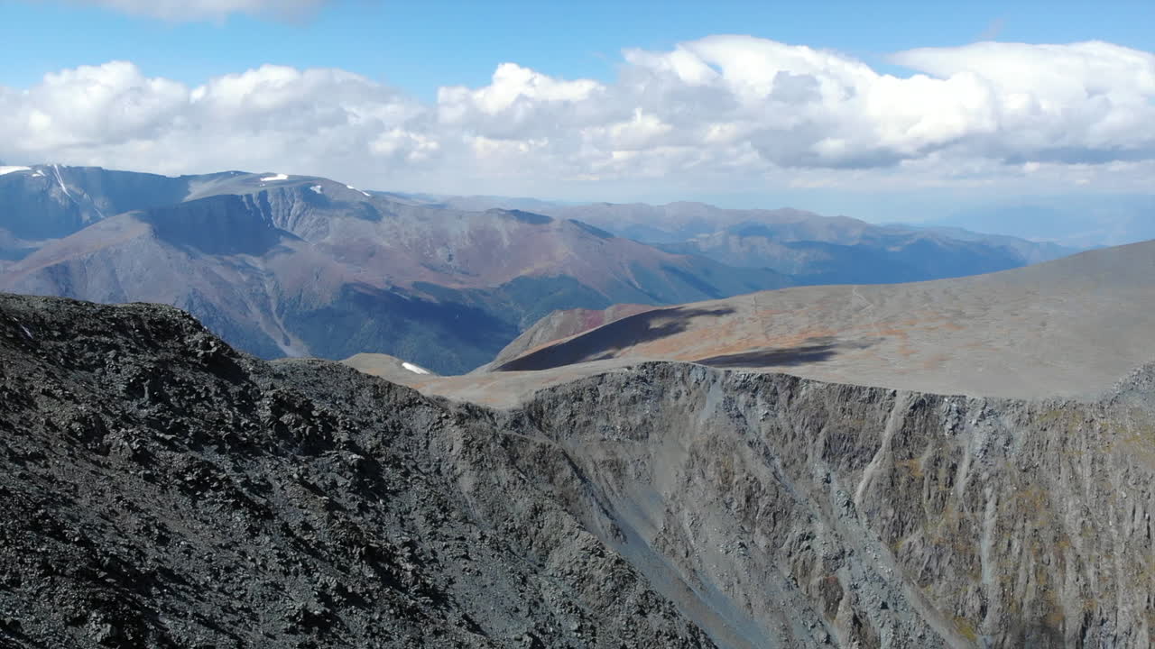 Vast Mountain Landscape with Rocky Peaks and Cloudy Sky