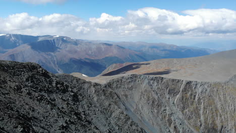 vast mountain landscape with rocky peaks and cloudy sky
