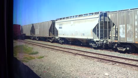 The-view-from-the-window-of-a-moving-train-passing-train-carriages