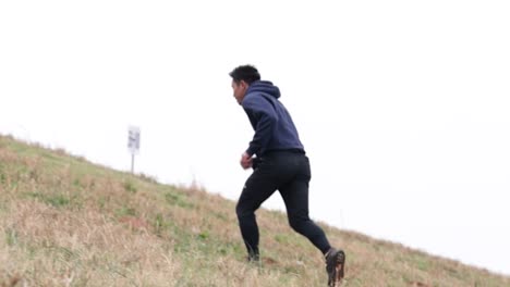 asian male running up hill