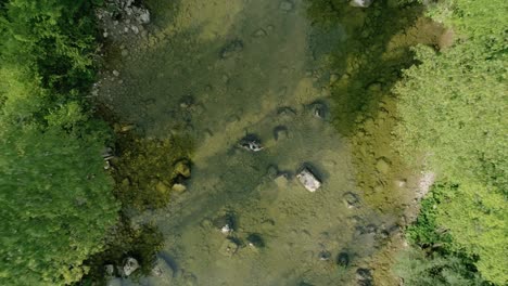 Drone-bird-eye-view-of-a-fly-fisherman-in-the-middle-of-a-beautiful-mountain-river