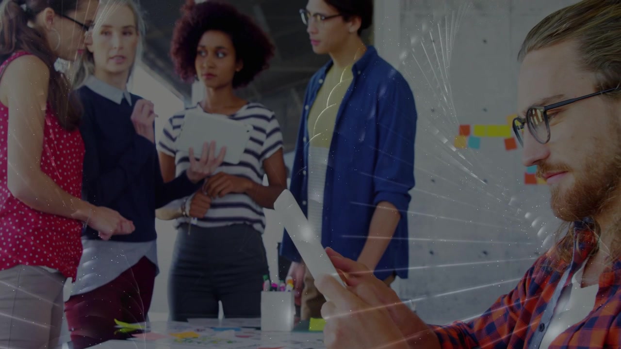 Team of five meeting left woman placing sticky note and tablet overlay marking notes for business