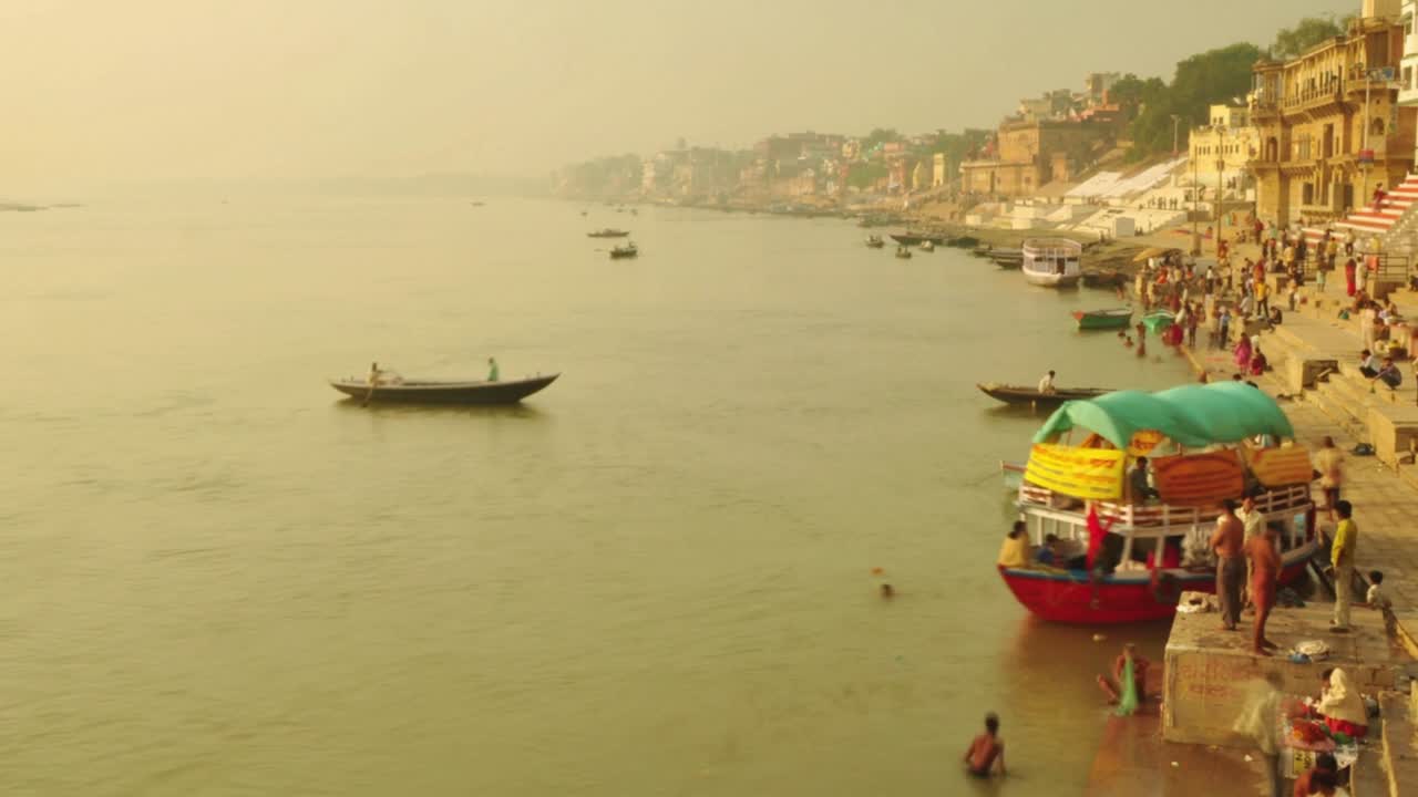 Time lapse Indian pilgrims rowing boat in sunrise. Ganges river at Varanasi India.