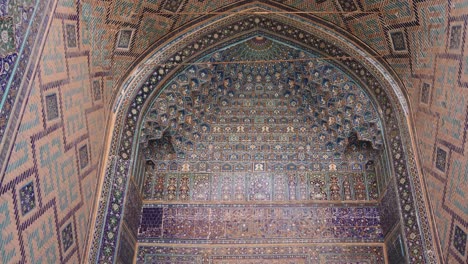 detailed blue tiling on historic archway entering a traditional mosque in registan square in samarkand, uzbekistan along the historic silk road