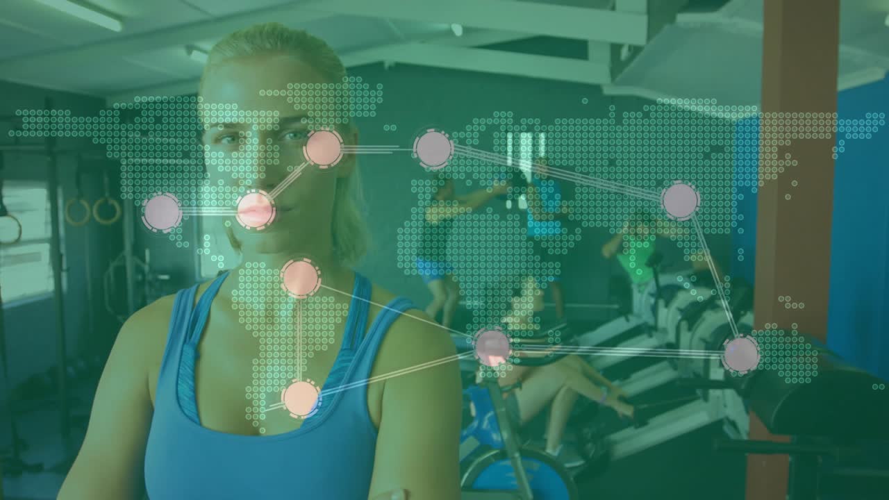 Woman standing arms crossed in gym, fitness band sending training data, animated map lighting nodes
