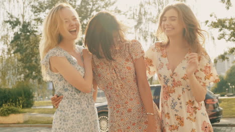 three happy young women enjoying a sunny day outdoors