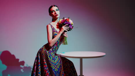 elegant woman in a vibrant patterned dress with a bouquet