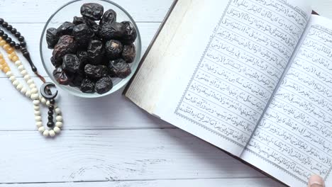 holy book quran and prayer beads on table, close up.