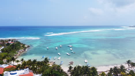 Aerial-landscape-view-of-the-beach-in-Akumal-in-the-Mayan-Riviera,-México-during-a-sunny-day