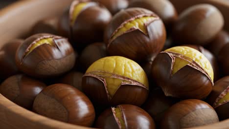 a bowl of roasted chestnuts, some partially peeled