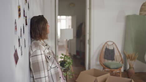 tired man leaning against wall during a move