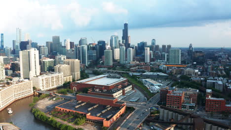 Aerial-view-of-Chicago-River-and-skyscrapers-creating-shadows-on-water's-surface,-Cars-running-on-Chicago-river-bridge