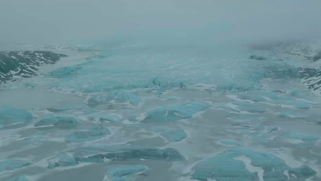 Highlands-of-Iceland,-Aerial-View-of-Glacier,-Glacial-Lake-and-Icebergs-on-Misty-Day,-Drone-Shot