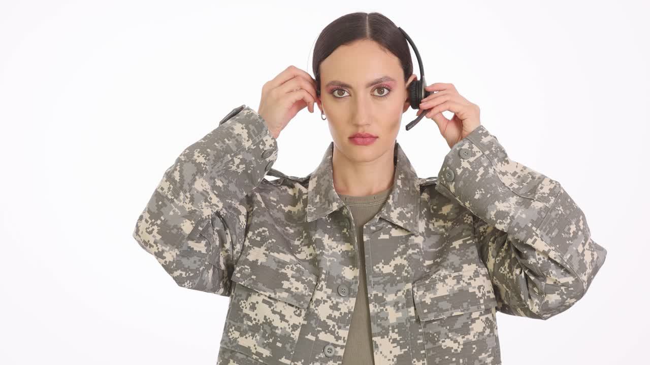 Woman in Military Uniform Adjusting Headset