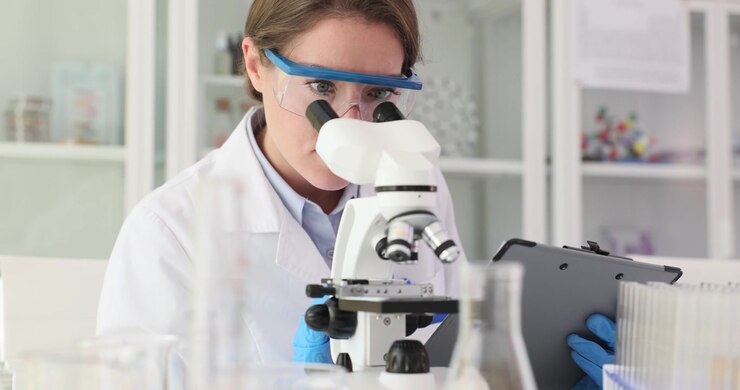 Scientist uses microscope to observe tiny changes in sample