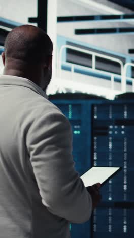 vertical video data center system administrator checks infrastructure diagnostics using tablet