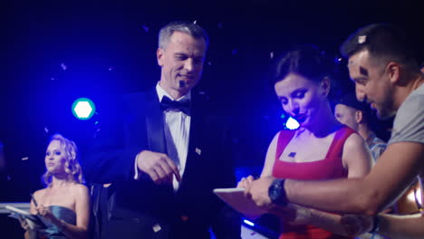 celebrities interacting with fans at a formal event