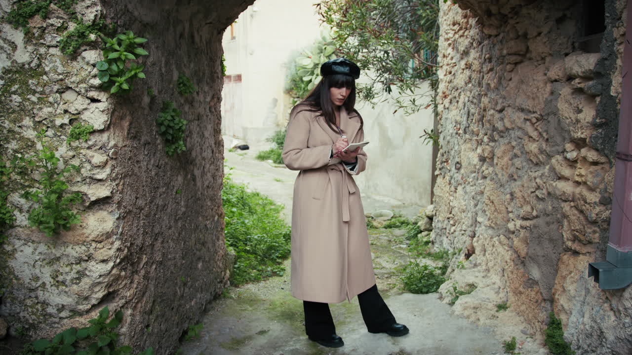 Woman Under The Arch Of A Medieval Town Taking Notes