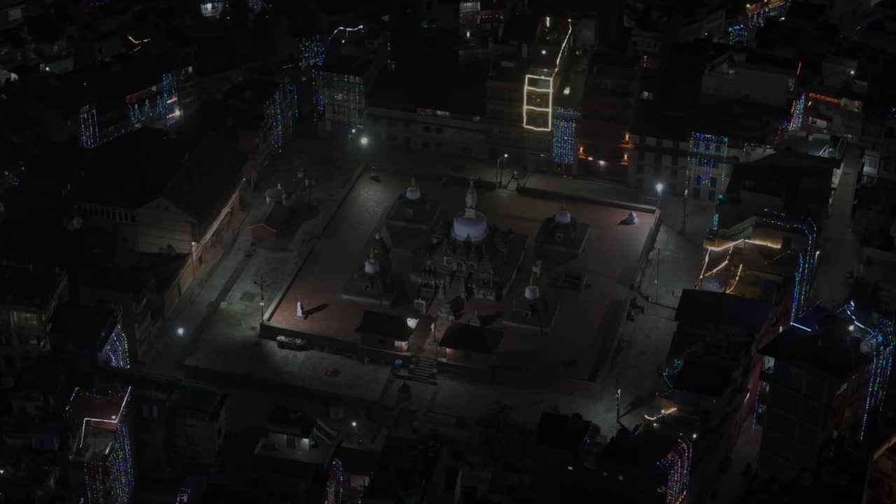 Aerial night footage of Kathmandu city during Diwali (Tihar), featuring the illuminated Dharahara Tower and glowing skyline filled with festive lights, showing Nepal’s vibrant cultural celebration