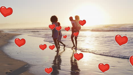 animation of hearts over african american family at beach