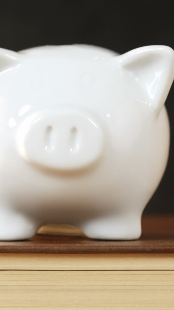 Close-up of books stack with piggy bank